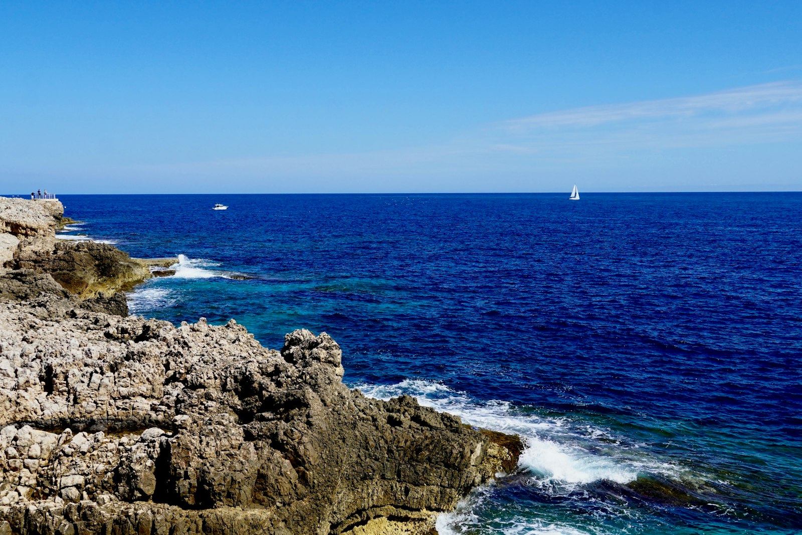Rocky French coastline and blue sea near nude and clothing-optional naturist resorts