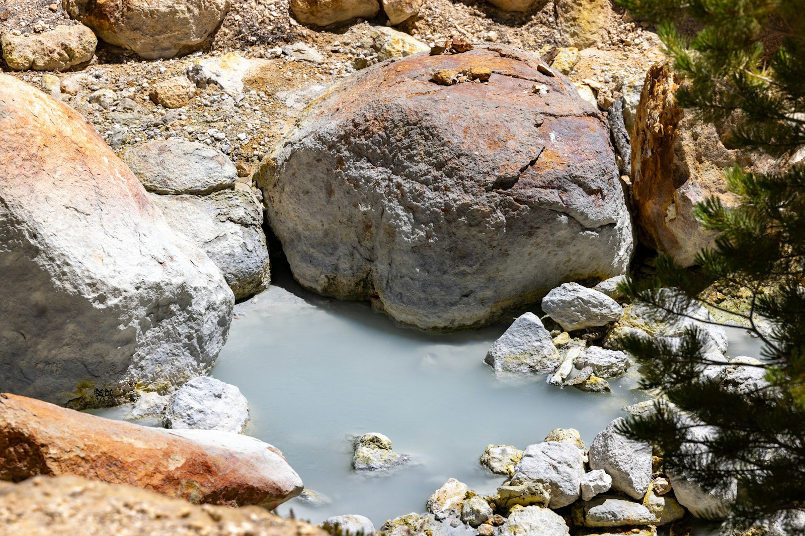 Milky blue natural rock hot spring pool suited to nude and clothing-optional soaking