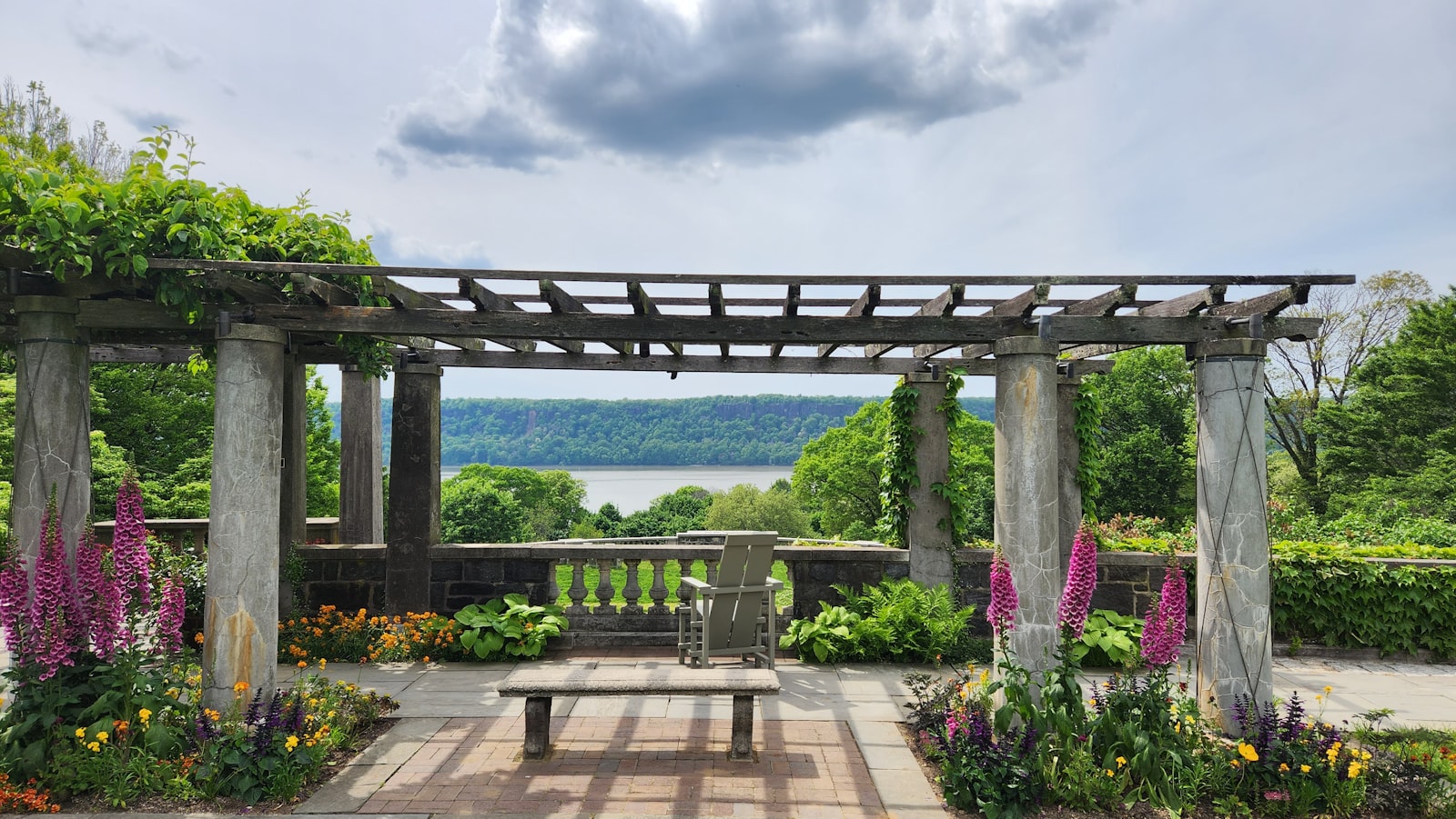 Shaded bench under a flowering pergola in nude and clothing-optional naturist club grounds