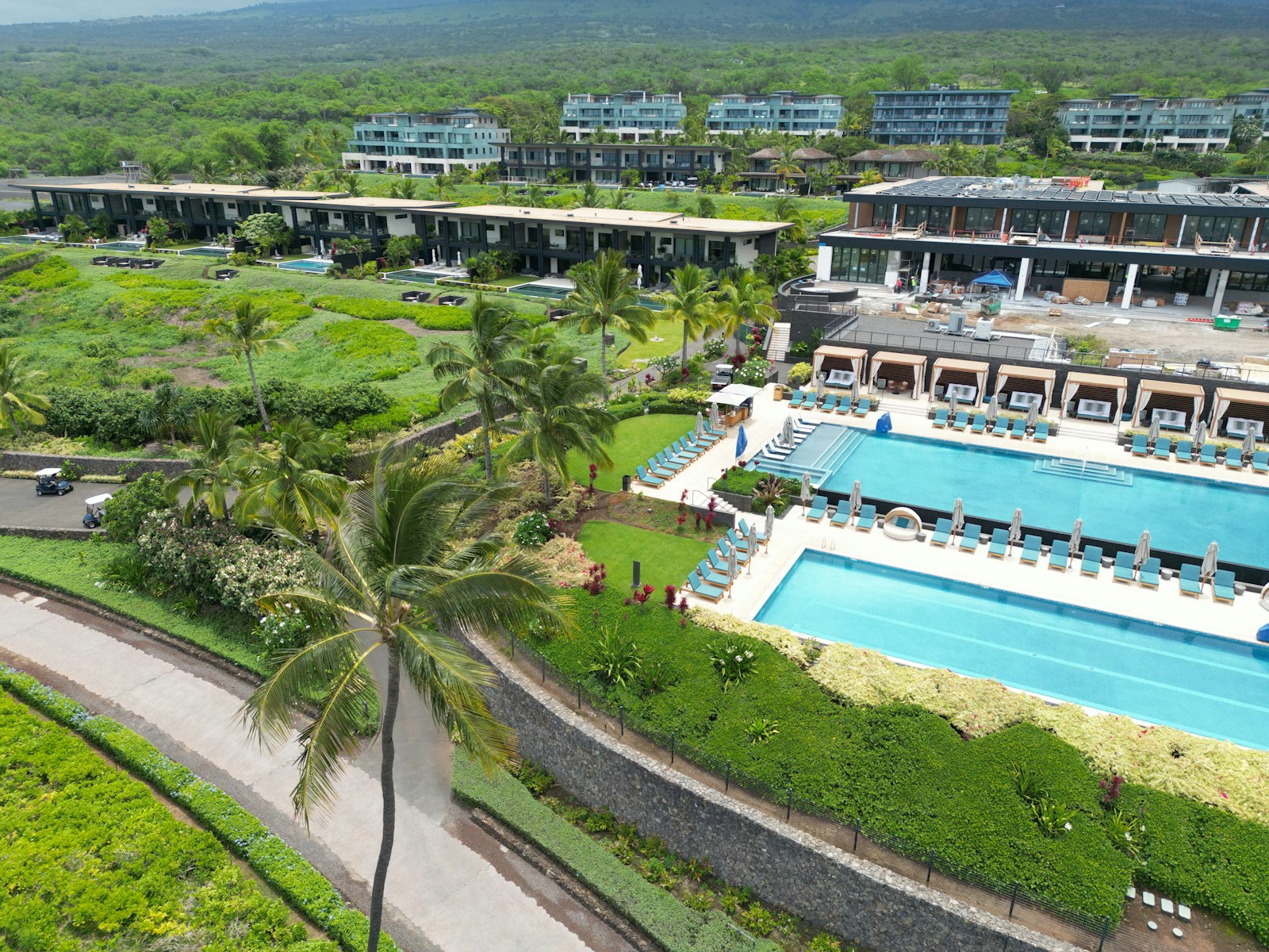 Tropical resort pools and palm trees like those at nude and clothing-optional resorts