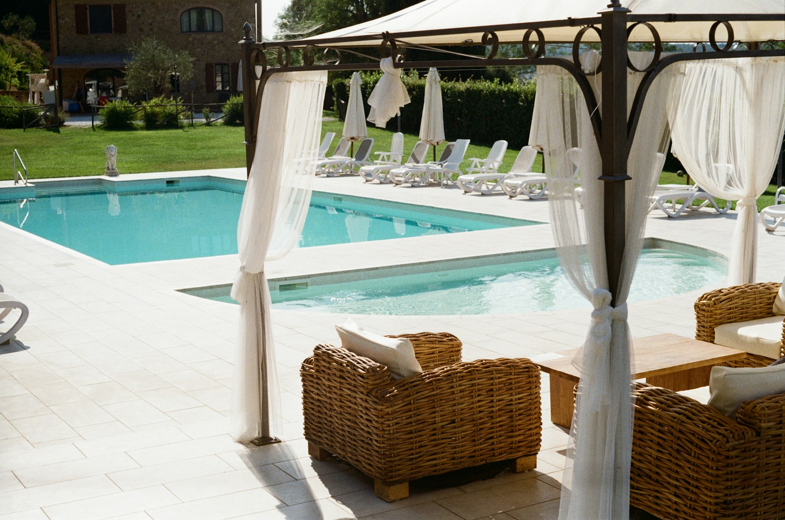 Outdoor resort pool with gazebo and loungers in a nude and clothing-optional resort setting